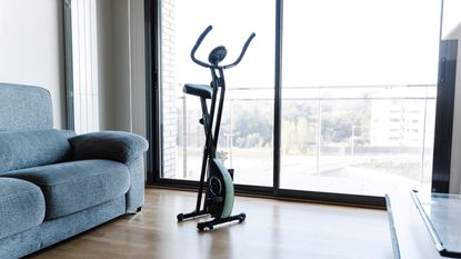 Reebok ZJET 460 Bluetooth Exercise Bike in a bright room with wooden floors.