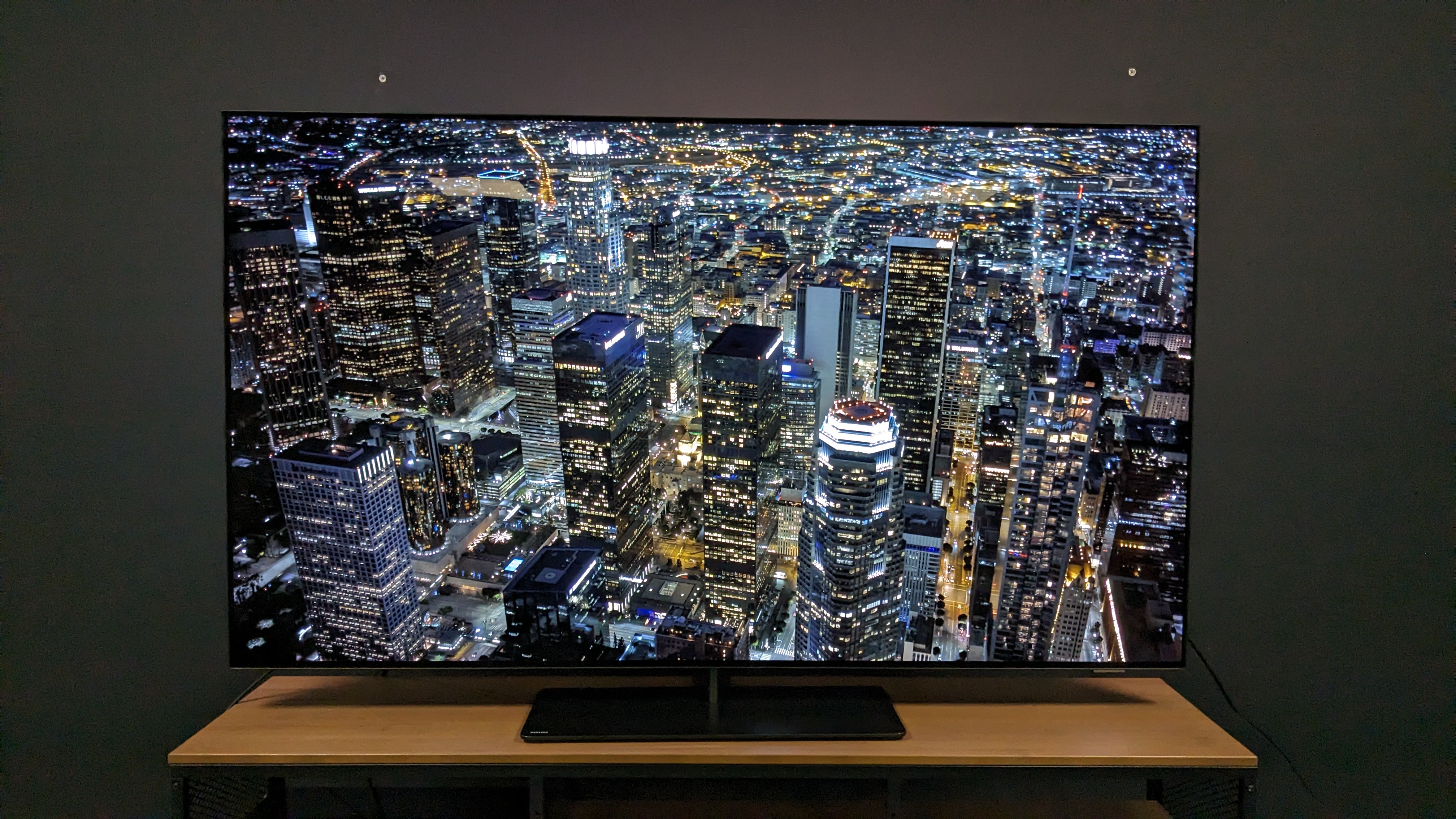 Philips OLED808 with aerial shot of city at night on screen