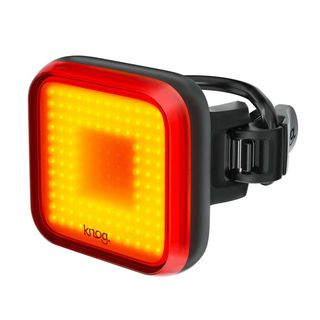 A red bike light on a white background