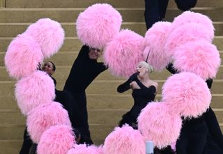 Lady Gaga performs in a heart of pink pom pom feathers at the 2024 Olympics