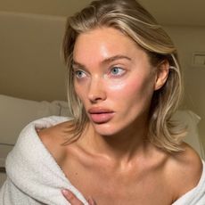Elsa Hosk with bare skin wearing a fluffy white dressing gown