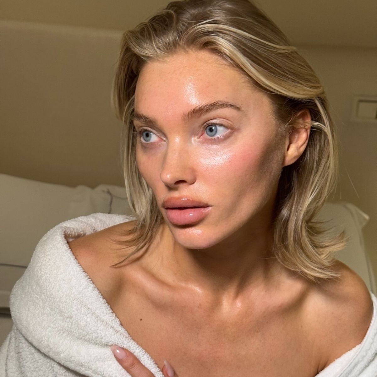 Elsa Hosk with bare skin wearing a fluffy white dressing gown