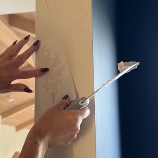 Floral 3D stencils being applied on an entrance to a room