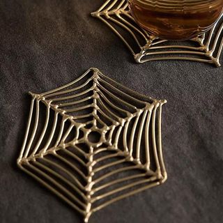 Gold wired coasters shaped like spiderwebs from Anthropologie