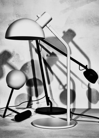 Black and white photograph showing a trio of table lamps