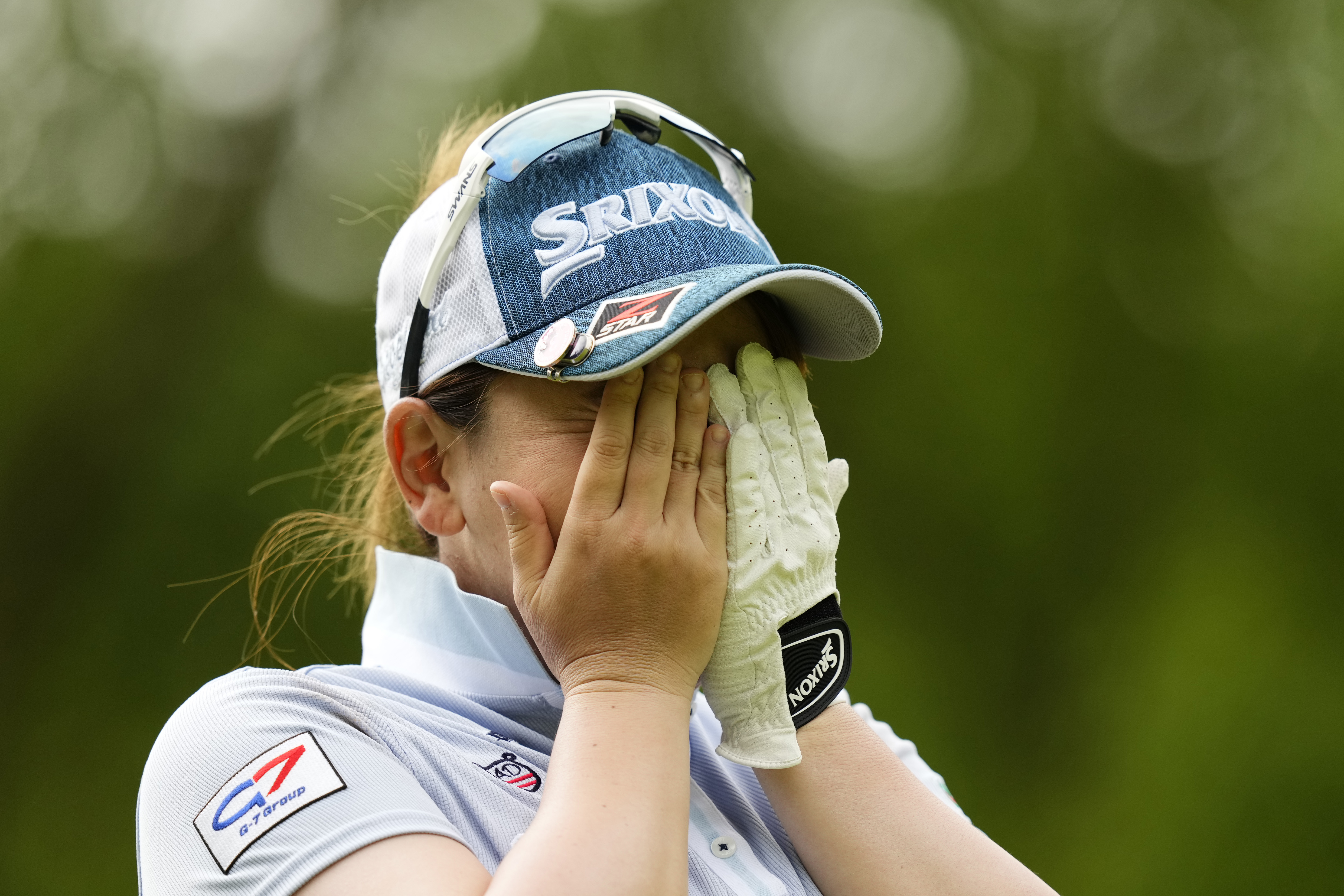 Yomiko Yoshida hides her face with her hands