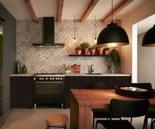 black low level kitchen units with geometric patterned splashback tiles and large black pendant lighting