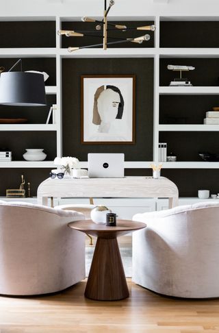 dark home office with white furnishings by Urbanology Designs