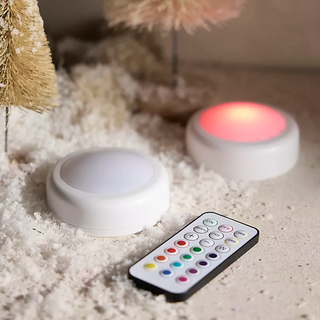 white color-changing puck light and remote