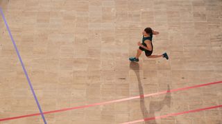 On Cloud X review: person running across a gymnasium, viewed from birds eye perspective