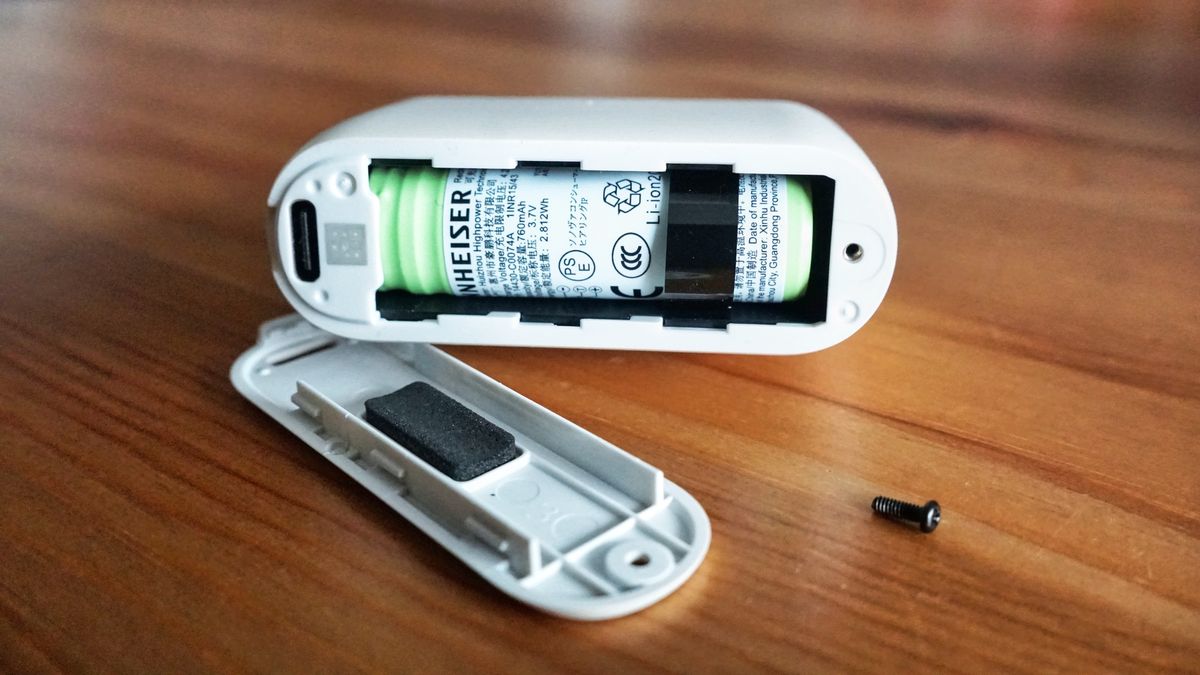 Sennheiser Momentum True Wireless 5 in white, showing details of the buds held in a hand