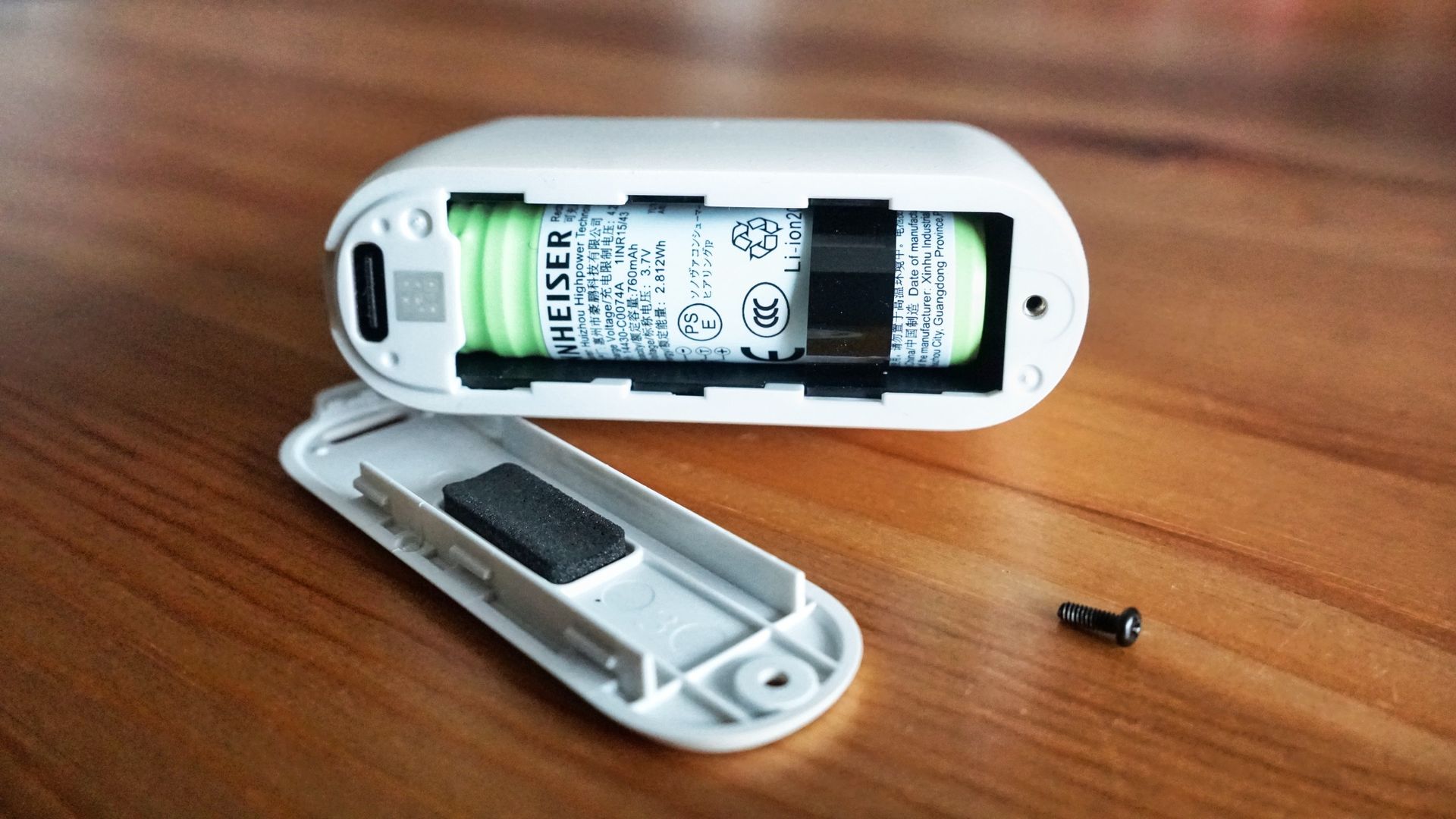 Sennheiser Momentum True Wireless 5 in white, showing details of the buds held in a hand