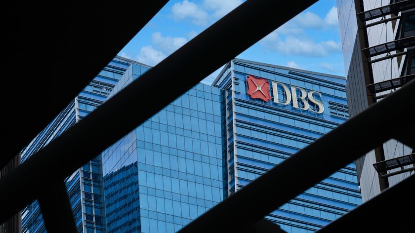 Exterior of the DBS Financial Building at Marina Bay including DBS Logo framed between the structures of the adjacent Marina Bay One Towers