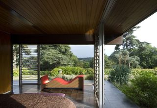 Pared-down, glass-enclosed design, and leafy English countryside setting