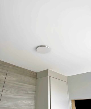 A kitchen ceiling showing kitchen units and a flat white vent, from Rega Ventilation, for a MVHR system