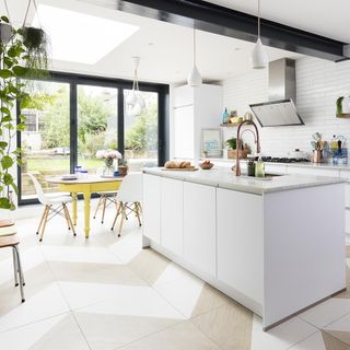 white kitchen with cabinets and hanging pots