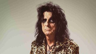 Alice Cooper posing for a photograph in a snakeskin suit in 2018