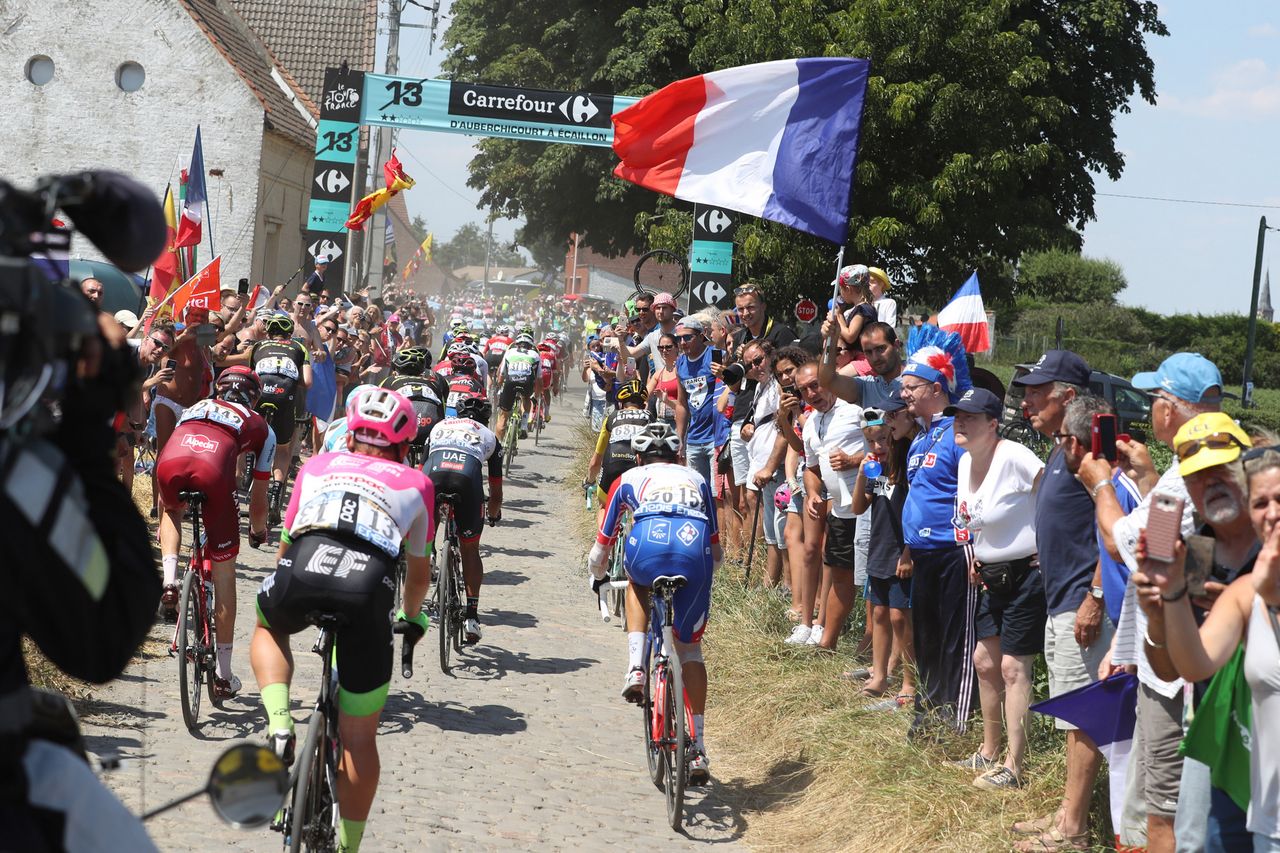 The French flags fly over the Tour de France as riders enter secteur 13