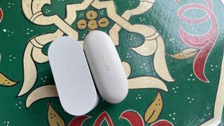 The Sony WF-10000XM6 next to the Sony WF-1000XM5, held in a hand, to show the size difference