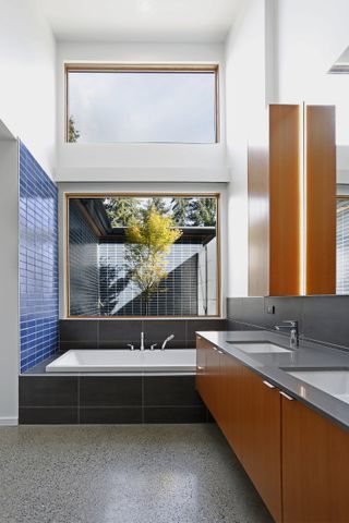 A bathroom using a complementary color palette of blue and orange