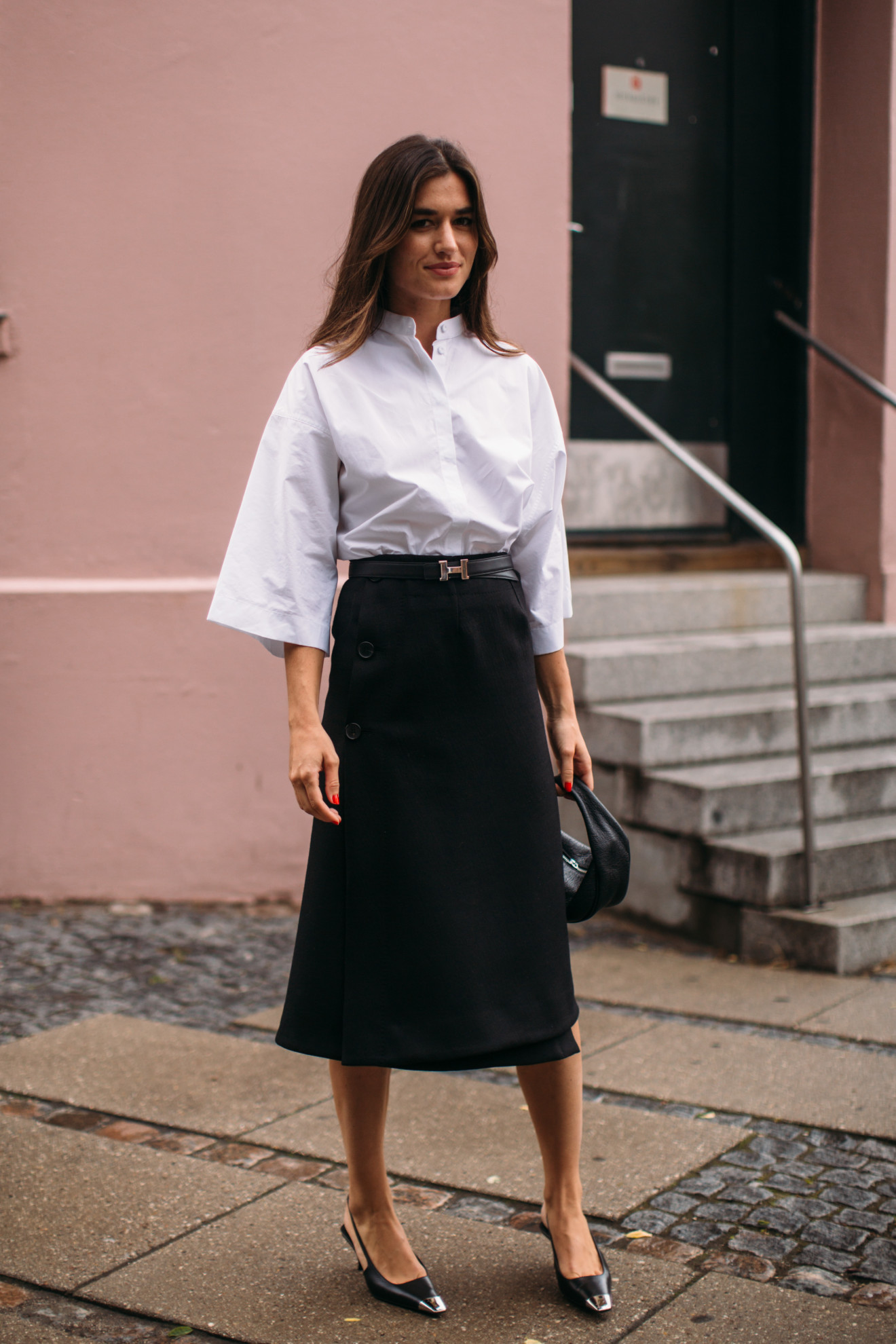woman wearing white button down shirt, black bottoms, and black heels