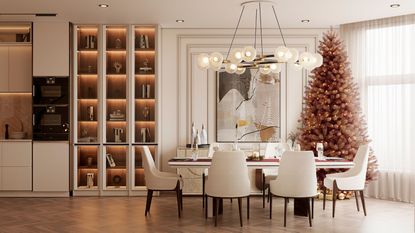 A dining kitchen space in neurtral colors with a brown Christmas tree