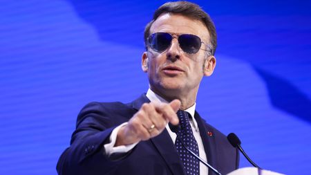 Emmanuel Macron delivering a speech in sunglasses