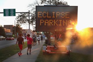 A sign directs visitors to parking areas to view the solar eclipse on August 19, 2017, in Carbondale, Illinois.