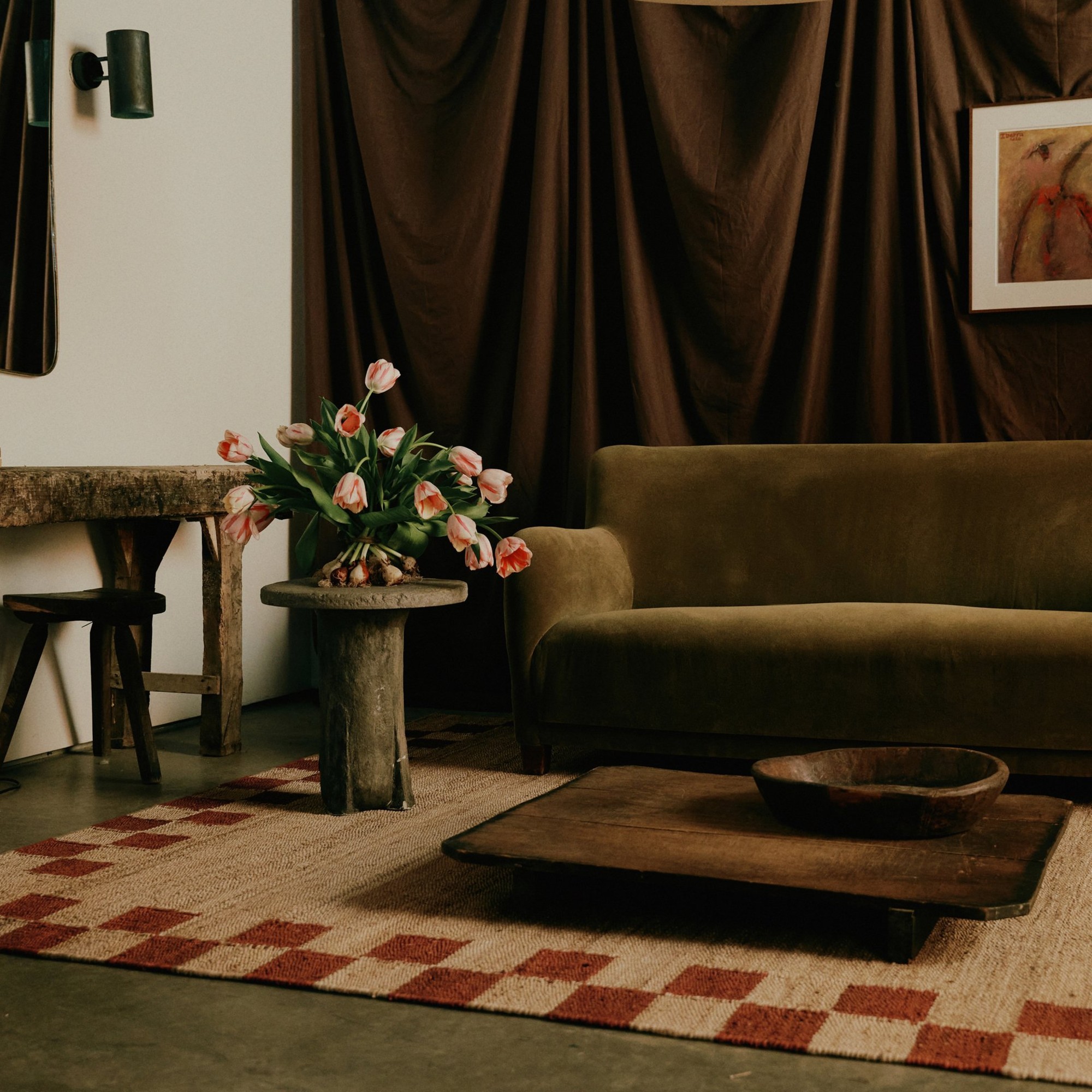 Nordic Knots&#039; jute rug with a chequered border in a living room with a brown velvet sofa