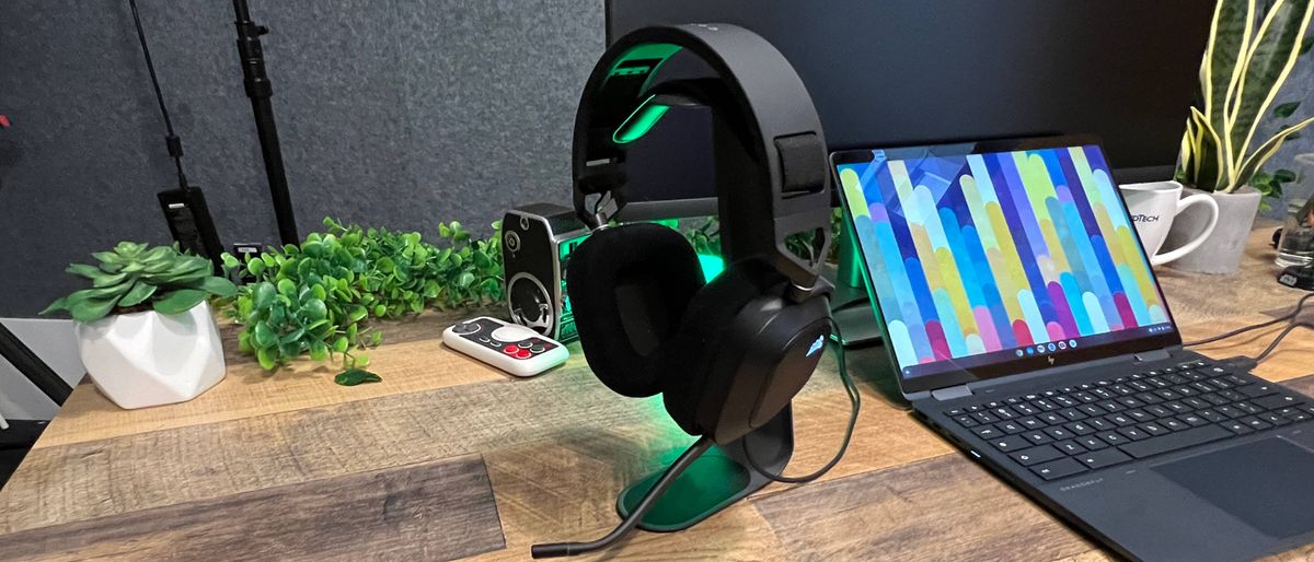 A Corsair HS80 USB on a headset holder on a desk