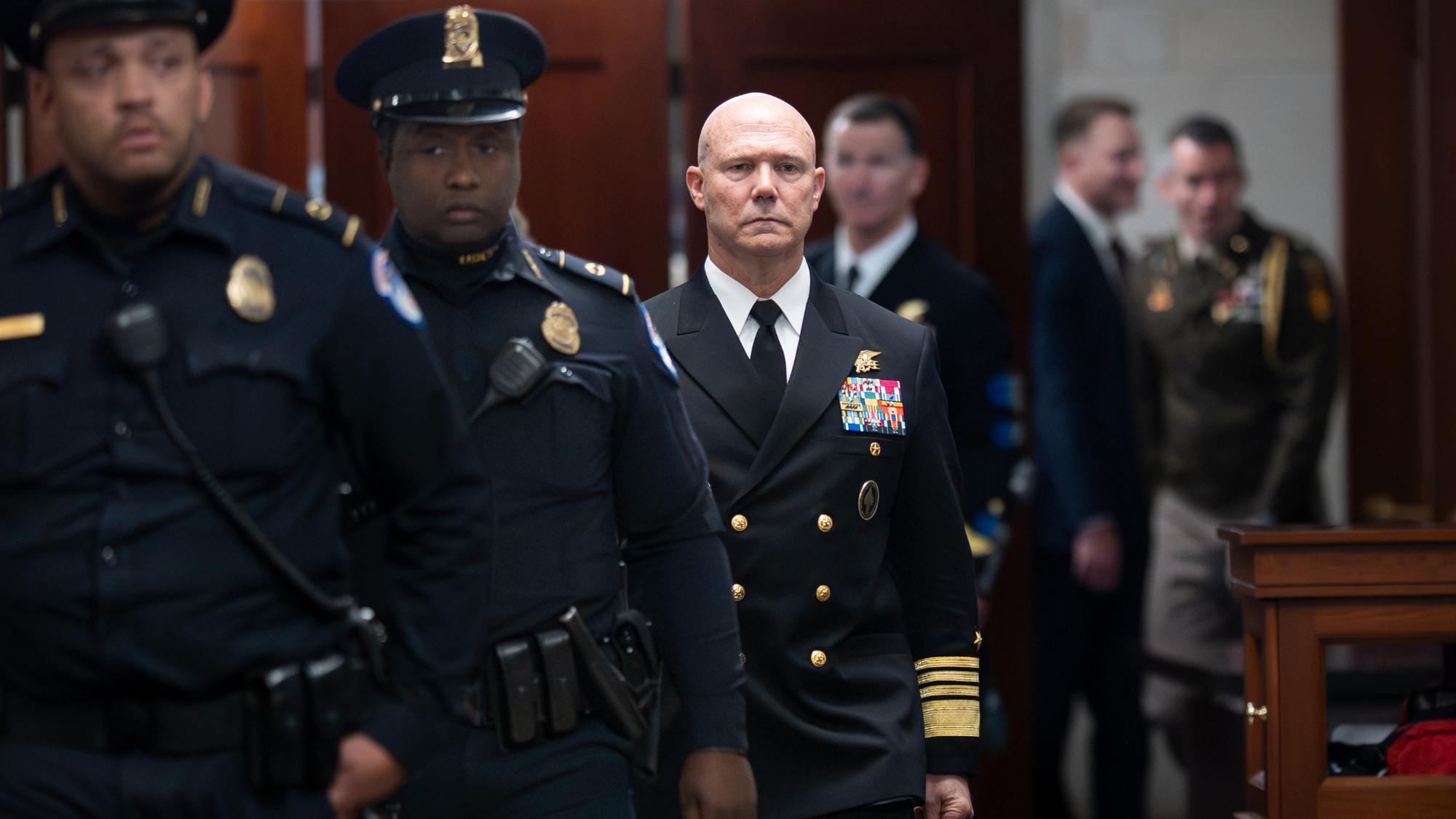 Adm. Frank Bradley walks to classified briefing on boat strike