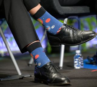 close up of blue socks with planets on them