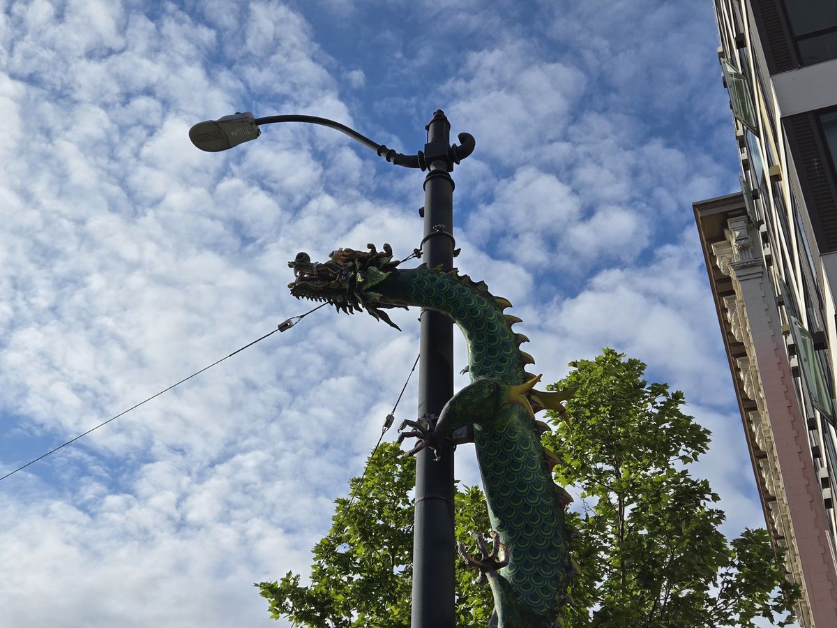 A dragon statue on a light pole