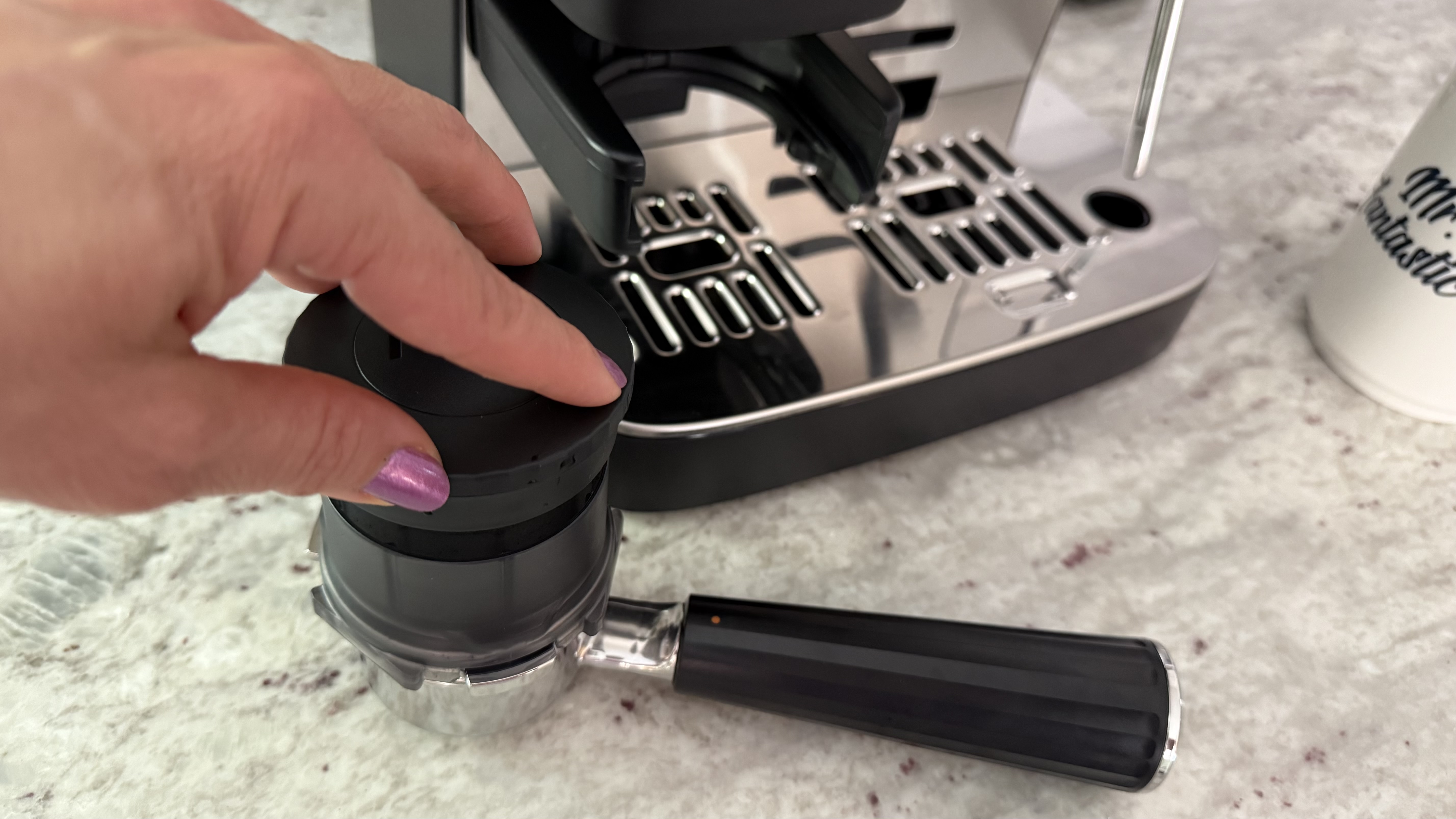 Ninja Luxe Café Mini Espresso Machine tamping down grounds