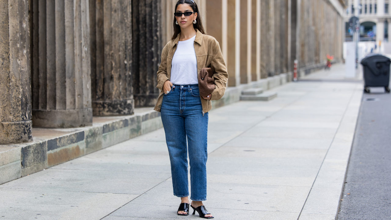 Bella Emar wears Levi’s blue denim jeans, white Cos t-shirt, brown Massimo Dutti Jacket, black H&amp;M Heels, Mango sunglasses during the Berlin Fashion Week SS25 on July 01, 2024 in Berlin, Germany. (Photo by Christian Vierig/Getty Images)