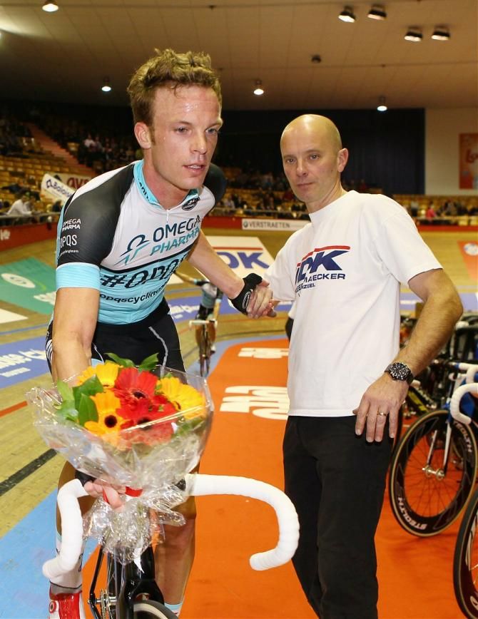 Iljo Keisse climbs off after taking the leader's flowers