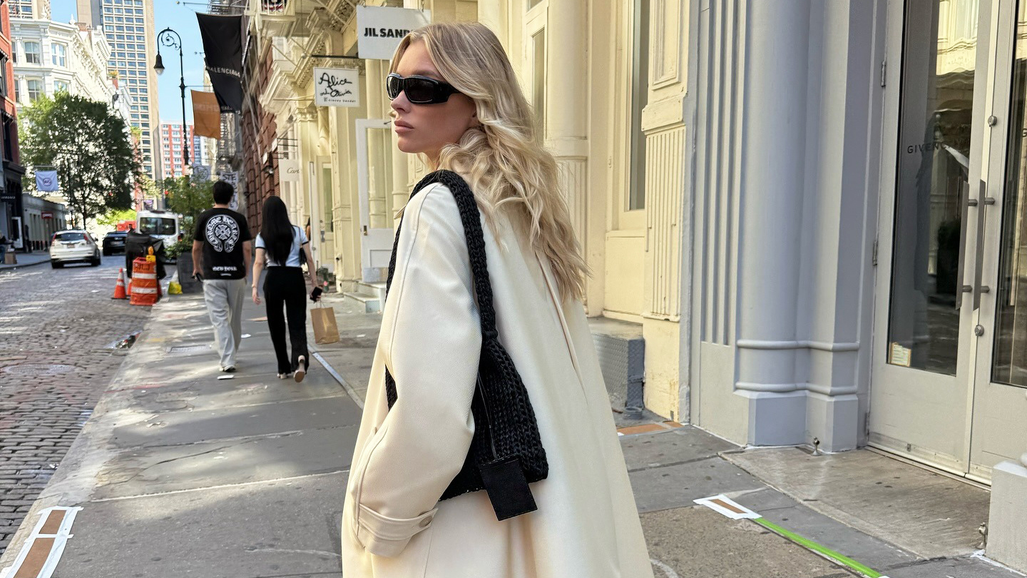Elsa Hosk wearing a white coat and black bag in NYC.