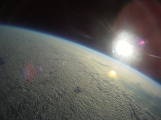 A shot by the Robonaut-1 balloon, looking down at Earth from the edge of space.