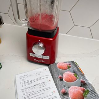 Blended banana and raspberry sorbet in Magmix Power Blender behind recipe book