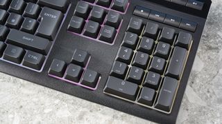 A black Corsair K55 RGB Pro wired gaming keyboard with rubber dome switches