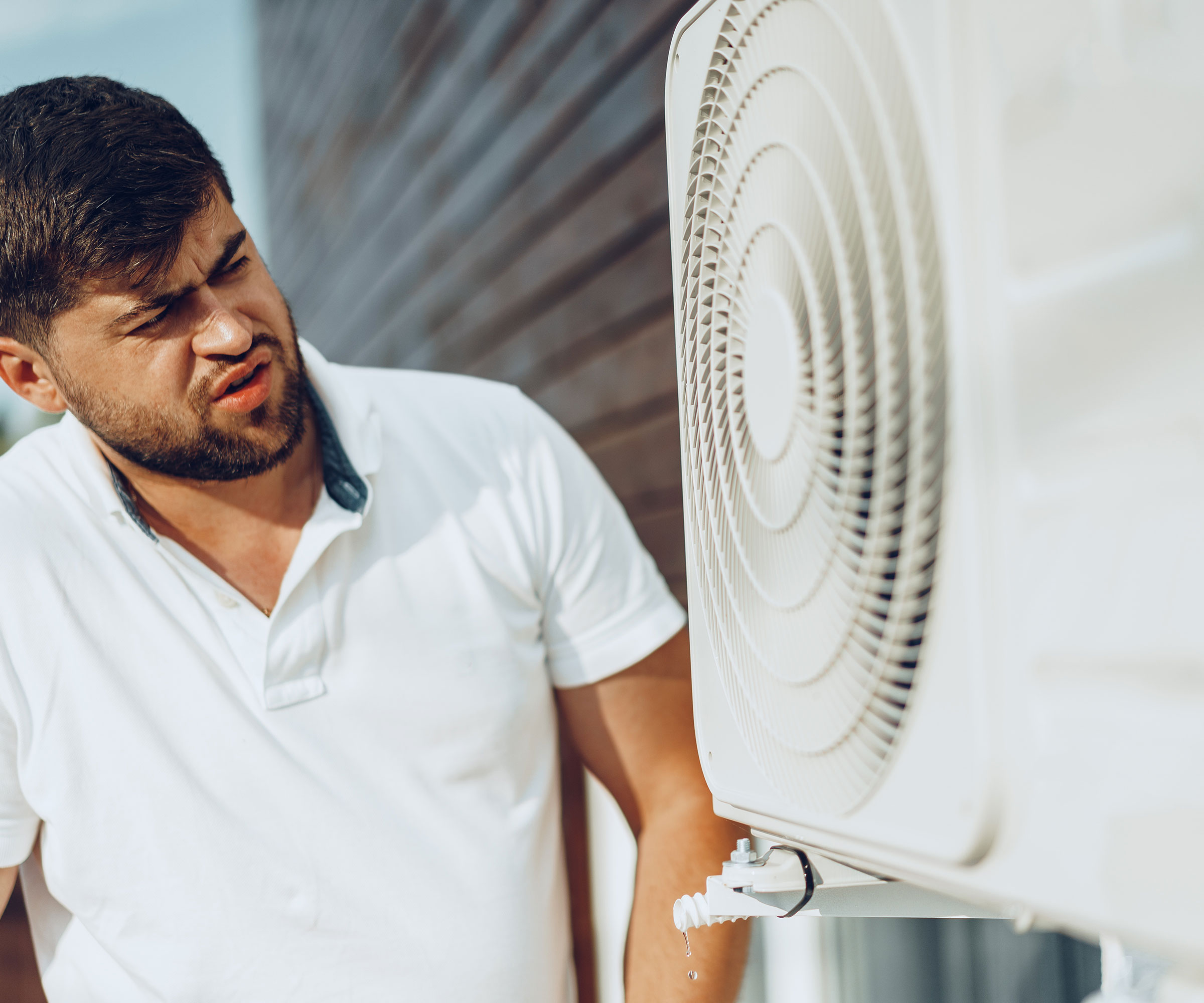 man looking at a heat pump