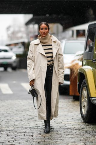 a woman at fashion week wearing a toteme sweater