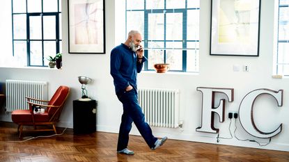 A businessman on the phone in a trendy loft office.