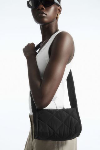 cos sale woman wearing quilted square crossbody bag