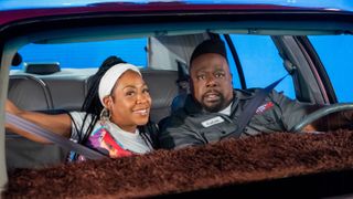 Tichina Arnold as Tina and Cedric the Entertainer as Calvin riding in a car in The Neighborhood season 6 finale