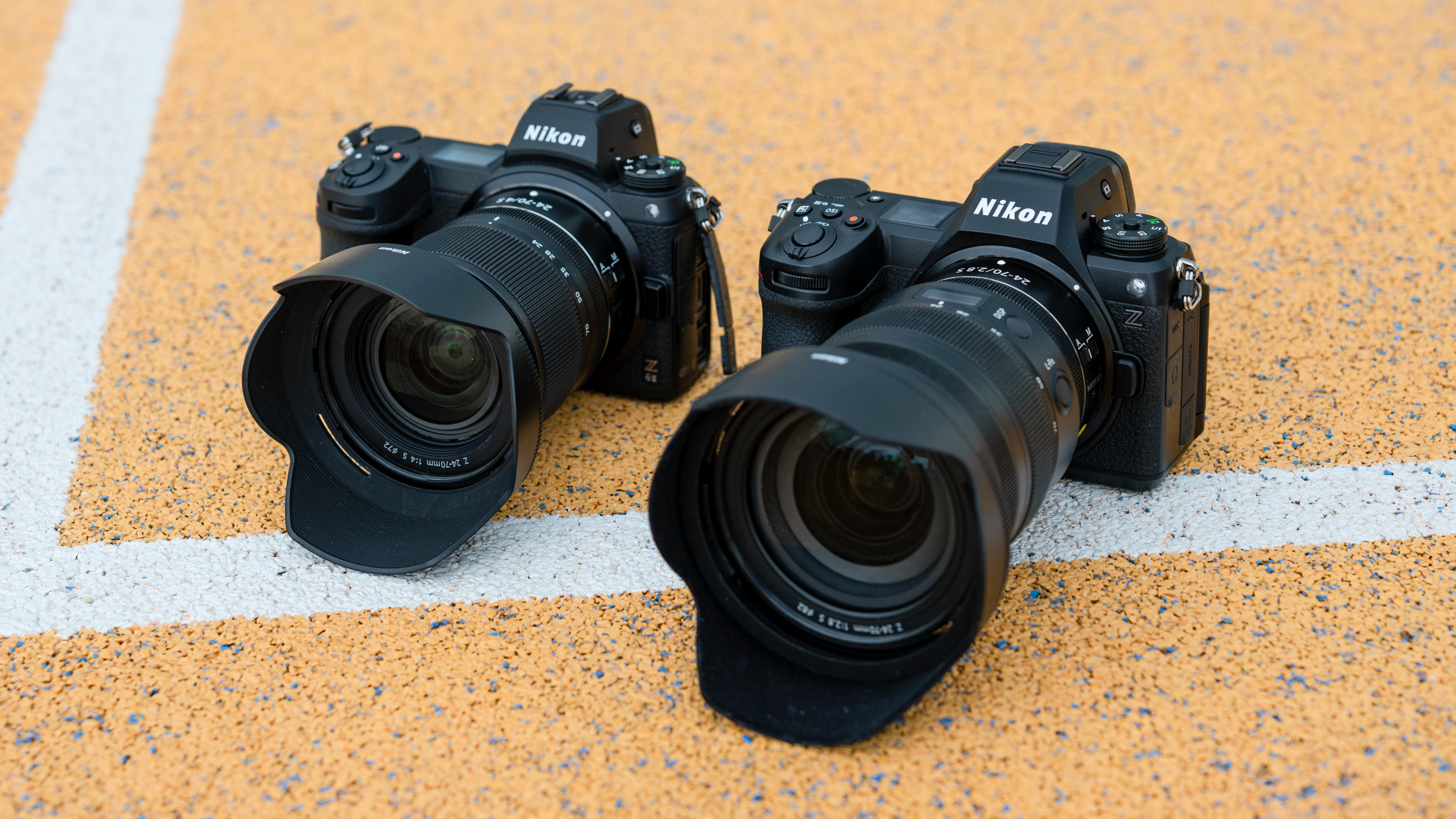 Nikon Z6 III camera next to a Nikon Z6 II camera on a basketball court