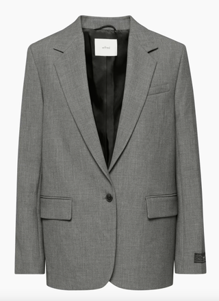 a gray blazer on a plain backdrop