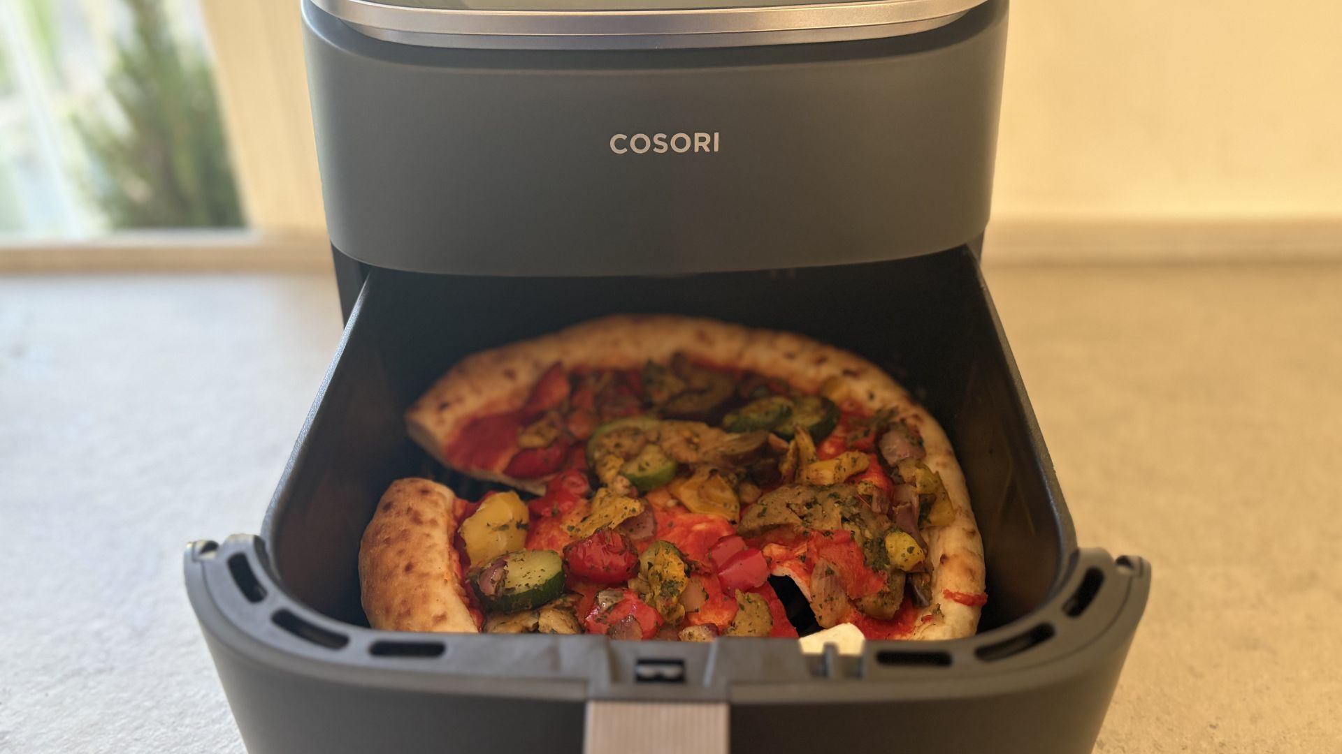 Testing the Cosori TurboBlaze 6L Air Fryer showing a pizza reheat