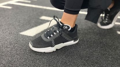 Person wearing Under Armour TriBase™ Reign 4 shoes.