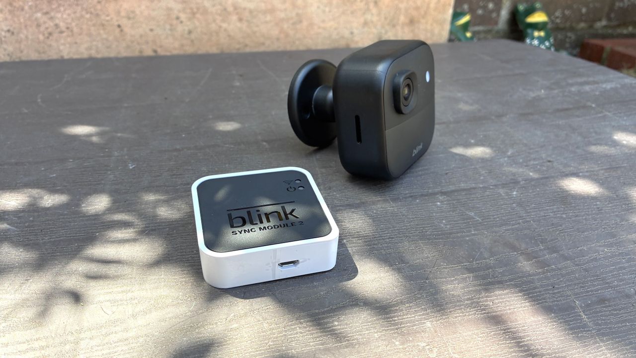 Blink Outdoor 2K+ security camera with hub on table